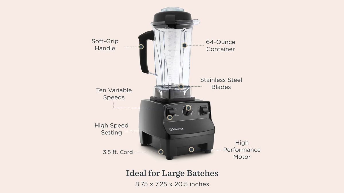 A black Vitamix blender on a white marble counter beside frozen bananas, kale, and oats in natural soft light.