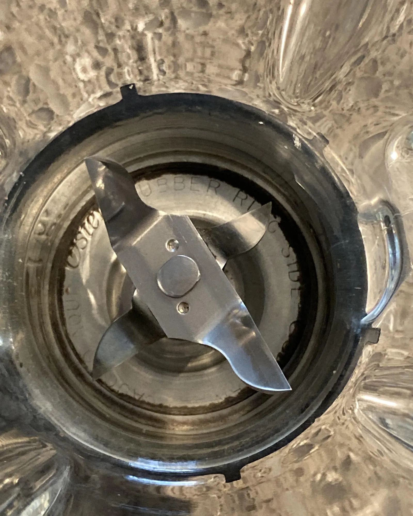 Blender replacement gasket, blade assembly and base cap on a workbench