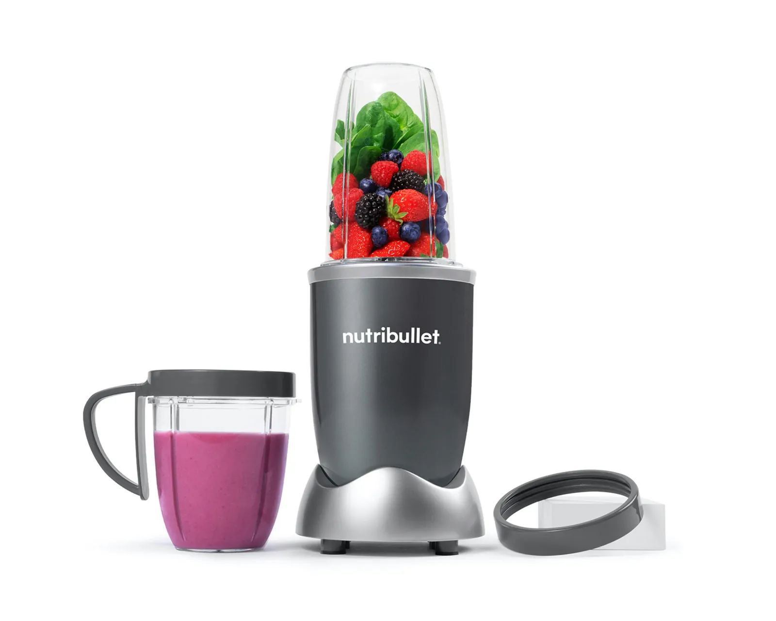 Bullet blender beside a juicer with orange juice and pulp
