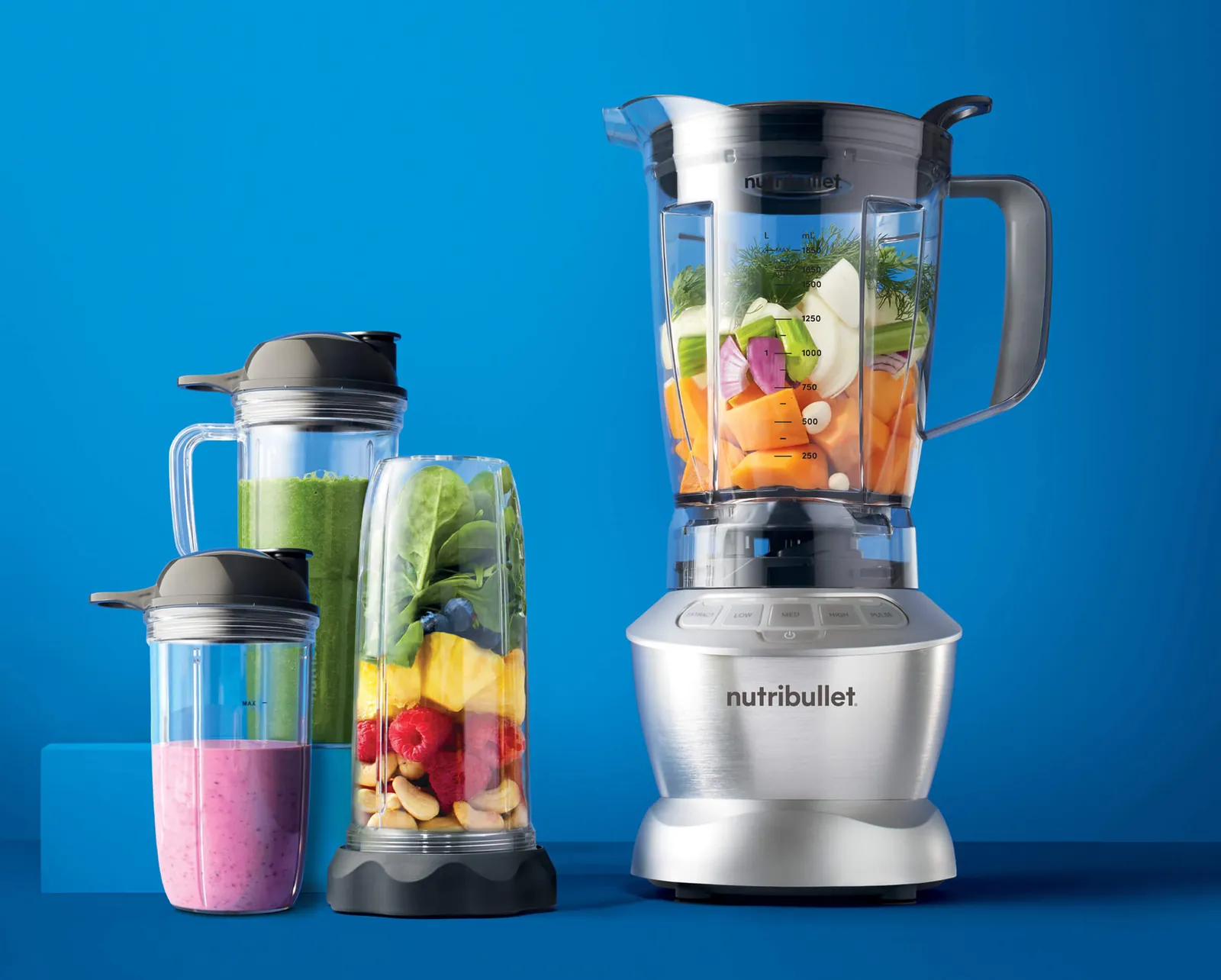 Bullet blender and glass of thick green smoothie side by side