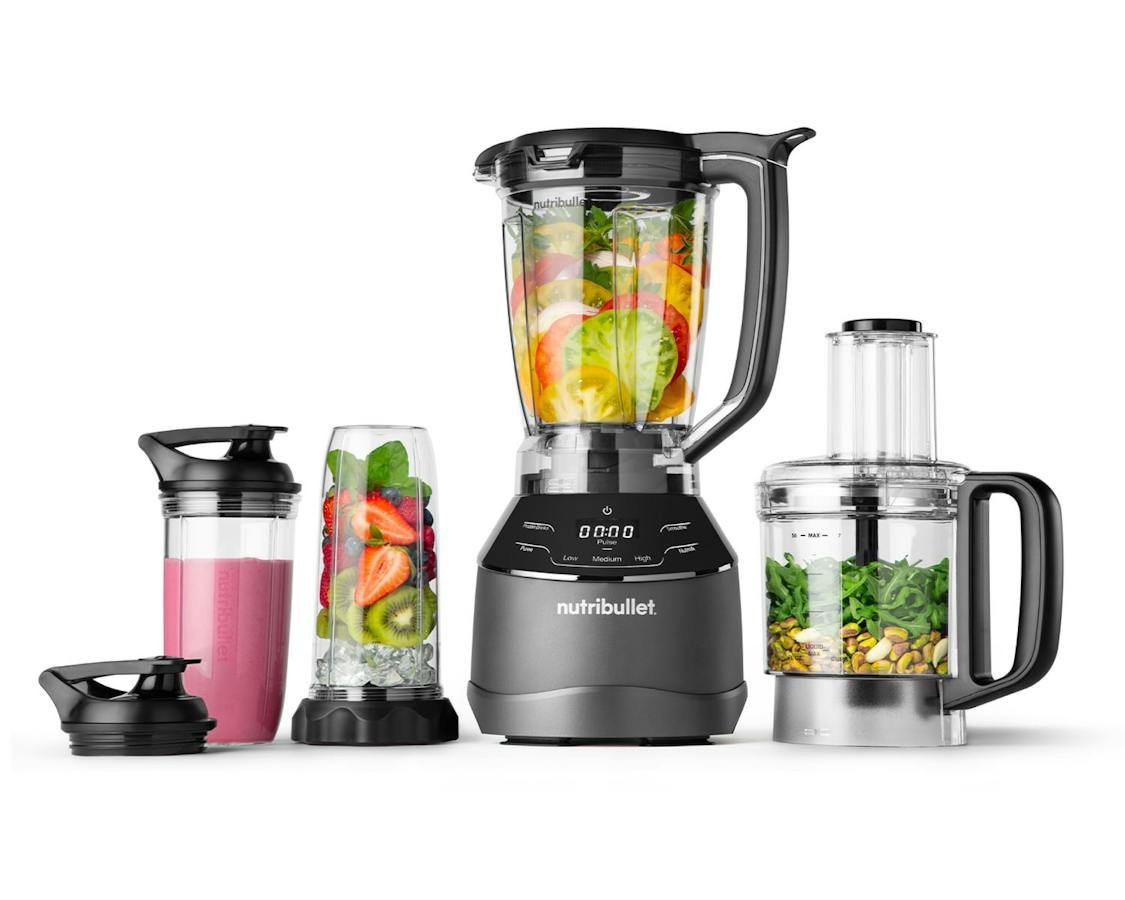 Cashews and water in a personal blender cup on a kitchen counter