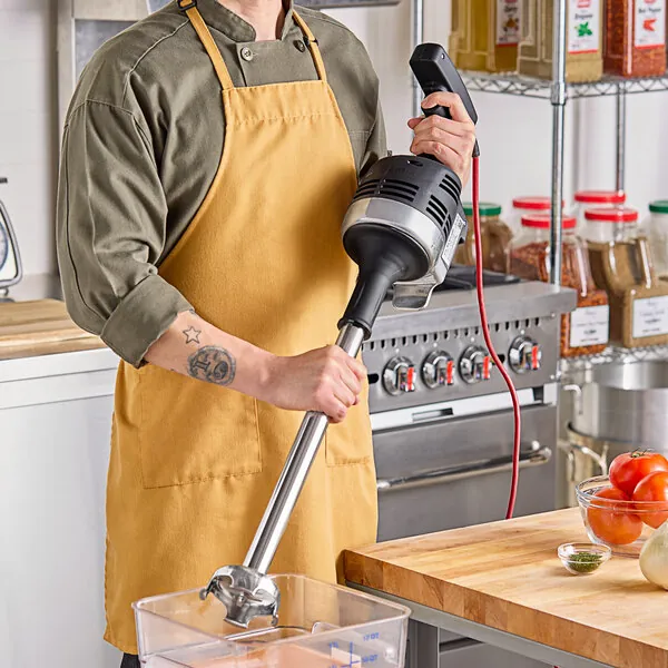 A food processor with sliced vegetables on a cutting board, emphasizing food preparation tools.