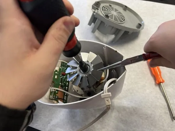 Frayed cord and cracked plug next to unplugged Oster blender base