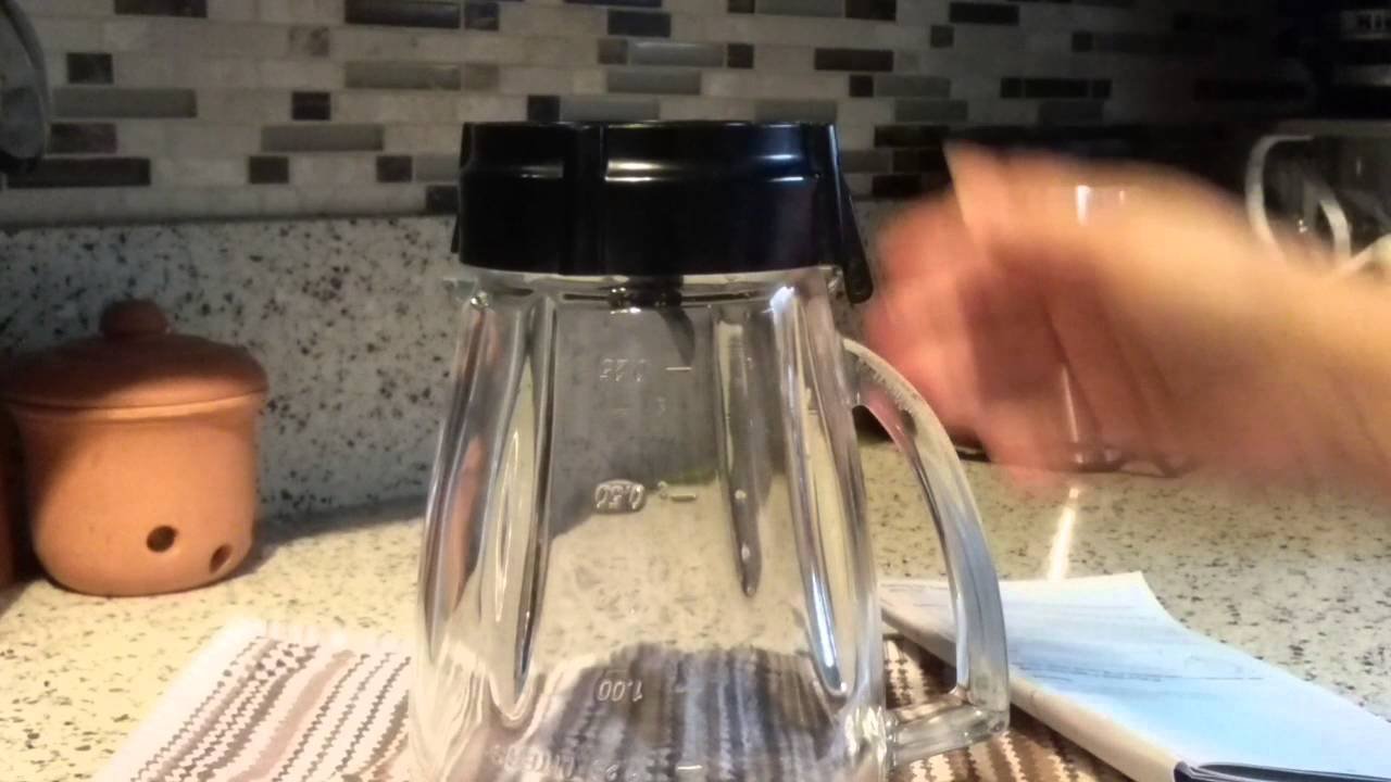Glass blender jar with base cap on kitchen counter for Oster blender repair