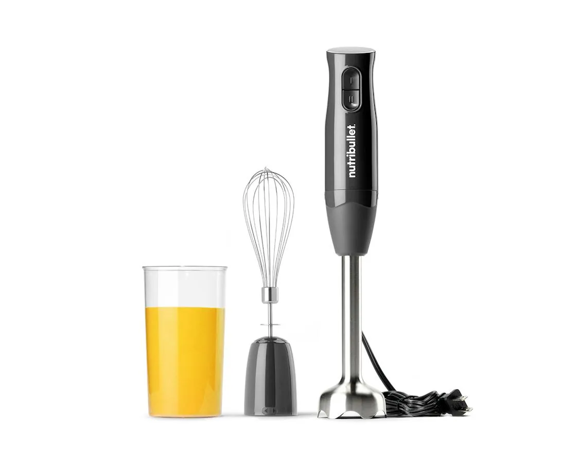 Half-filled blender cup of hot soup steaming on a kitchen counter