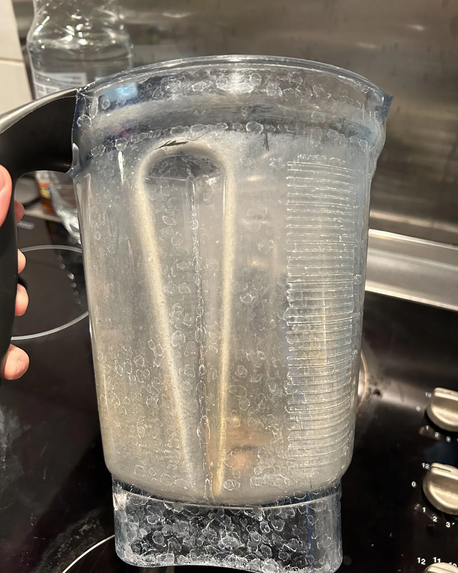 Hand inspecting the rubber seal ring on a Vitamix container