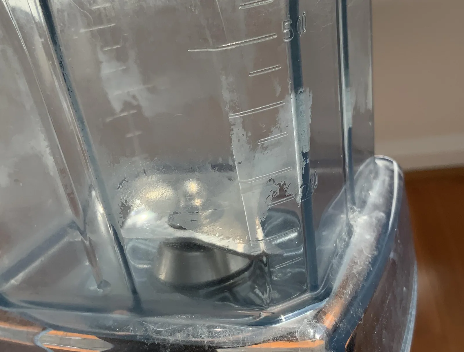 Hand scrubbing Vitamix blender jar with soapy water to remove stubborn food stains