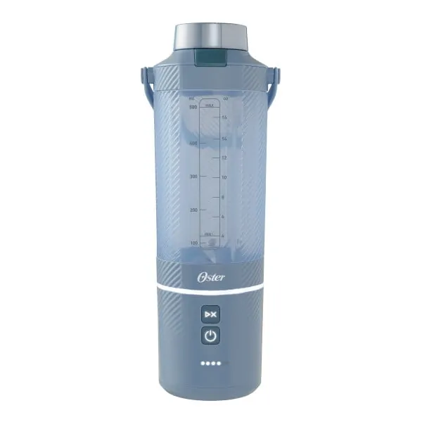 Hands operating a portable blender in a modern kitchen