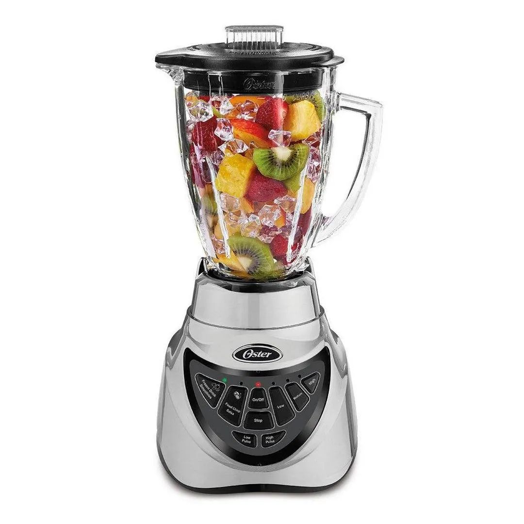 Hands pouring milk into a blender jar before adding frozen fruit