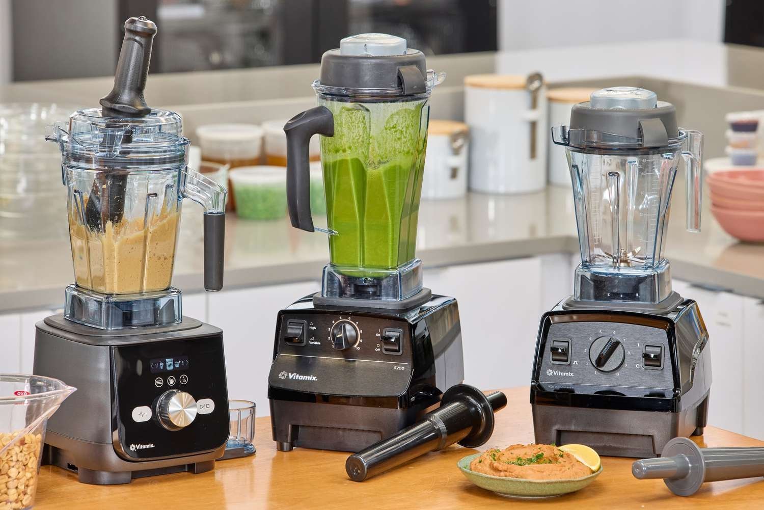 High-performance blender on a kitchen counter with fresh ingredients and hot soup