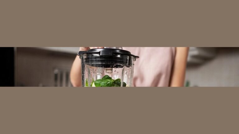 A high-performance blender sits on a marble countertop representing Vitamix power and wattage.