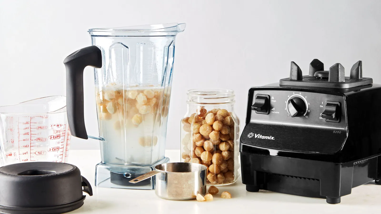 Home cook using a versatile Vitamix blender for daily meals in a modern kitchen.