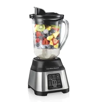 Immersion blender beside hot soup with Oster blender set aside