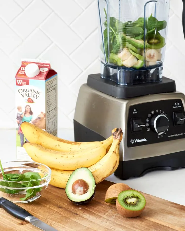 An immersion blender and a small personal blender displayed on a wooden surface.
