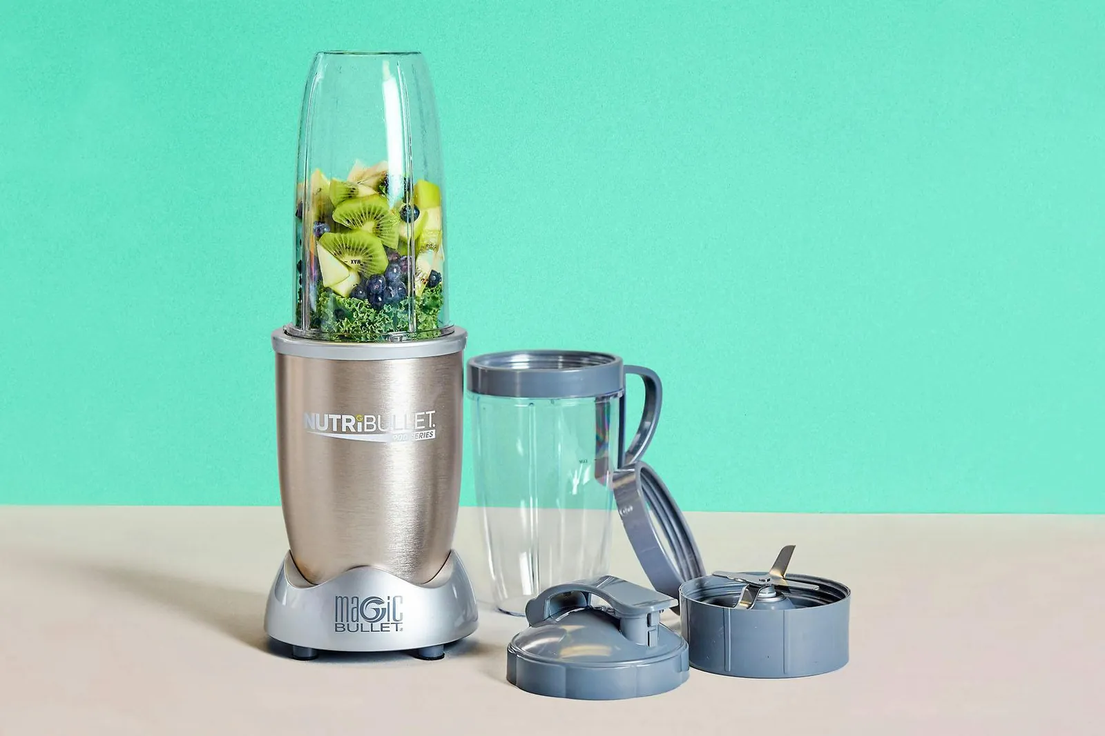 Large pitcher blender beside a small bullet blender on a kitchen counter
