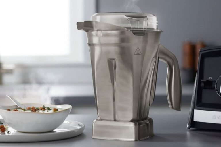 A modern Vitamix blender with a 48 oz container on a clean marble kitchen counter.