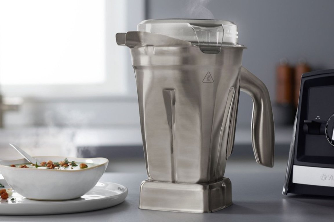 A modern Vitamix blender with a 48 oz container on a clean marble kitchen counter.
