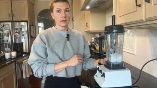 A modern Vitamix blender placed on a clean kitchen counter with fresh ingredients nearby.