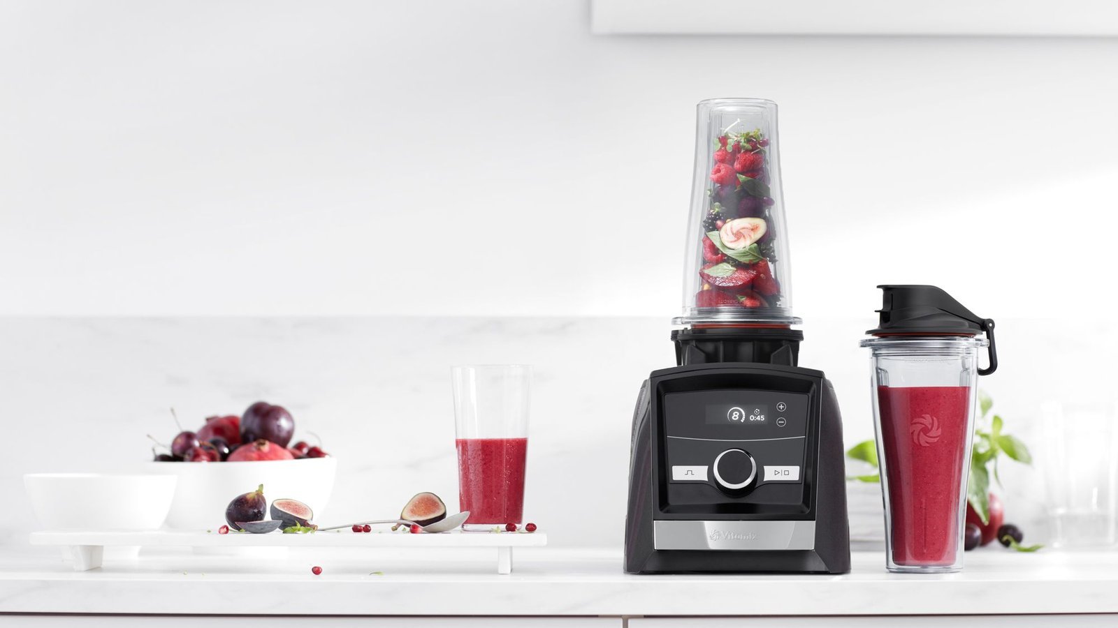 A modern Vitamix personal blender system ready for making fresh smoothies on a kitchen counter.