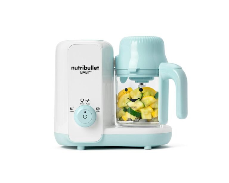 Nutribullet Baby steamer and blender on a kitchen counter with fresh vegetables and puree