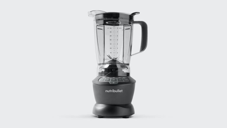 NutriBullet blender with large pitcher filled with green smoothie on kitchen counter