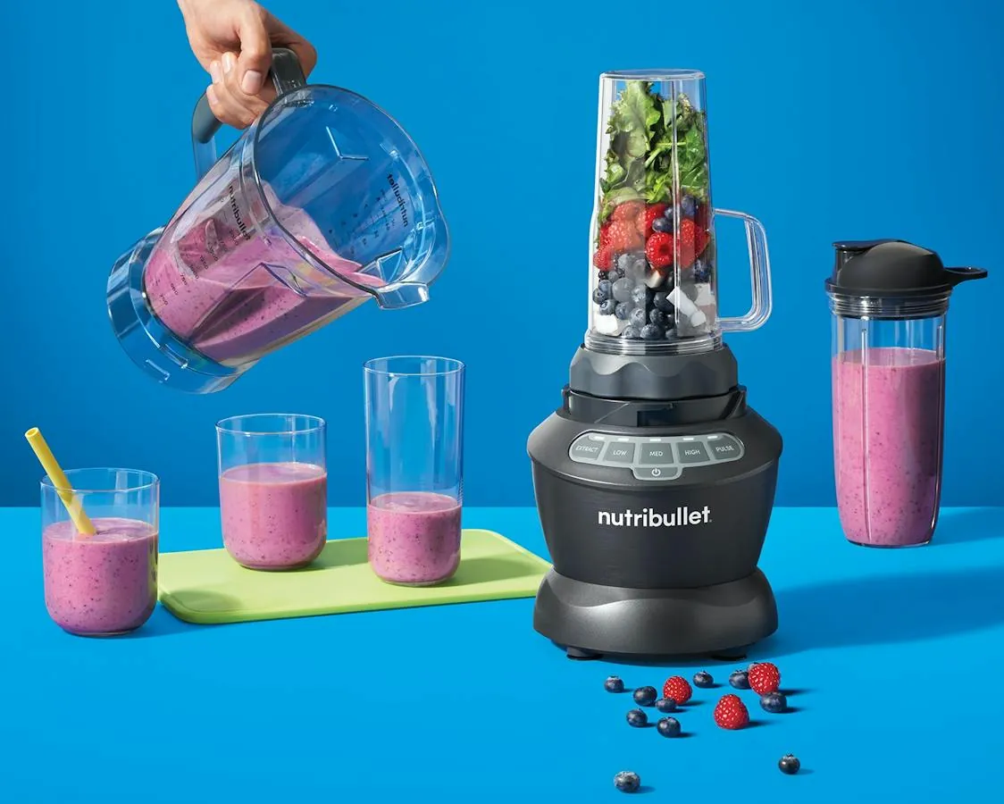 Nutribullet cup soaking in warm soapy water to loosen smoothie residue
