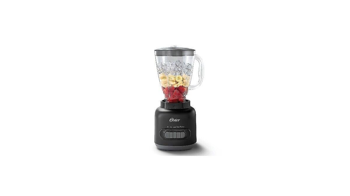 Oster blender with five speed dial on a bright kitchen counter with fresh fruit