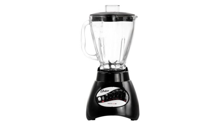 Oster blender with glass jar crushing ice on a kitchen counter