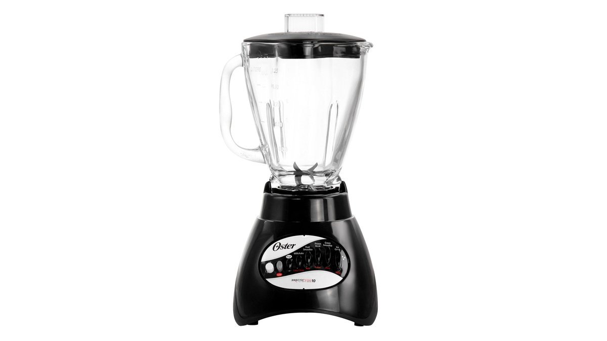 Oster blender with glass jar crushing ice on a kitchen counter