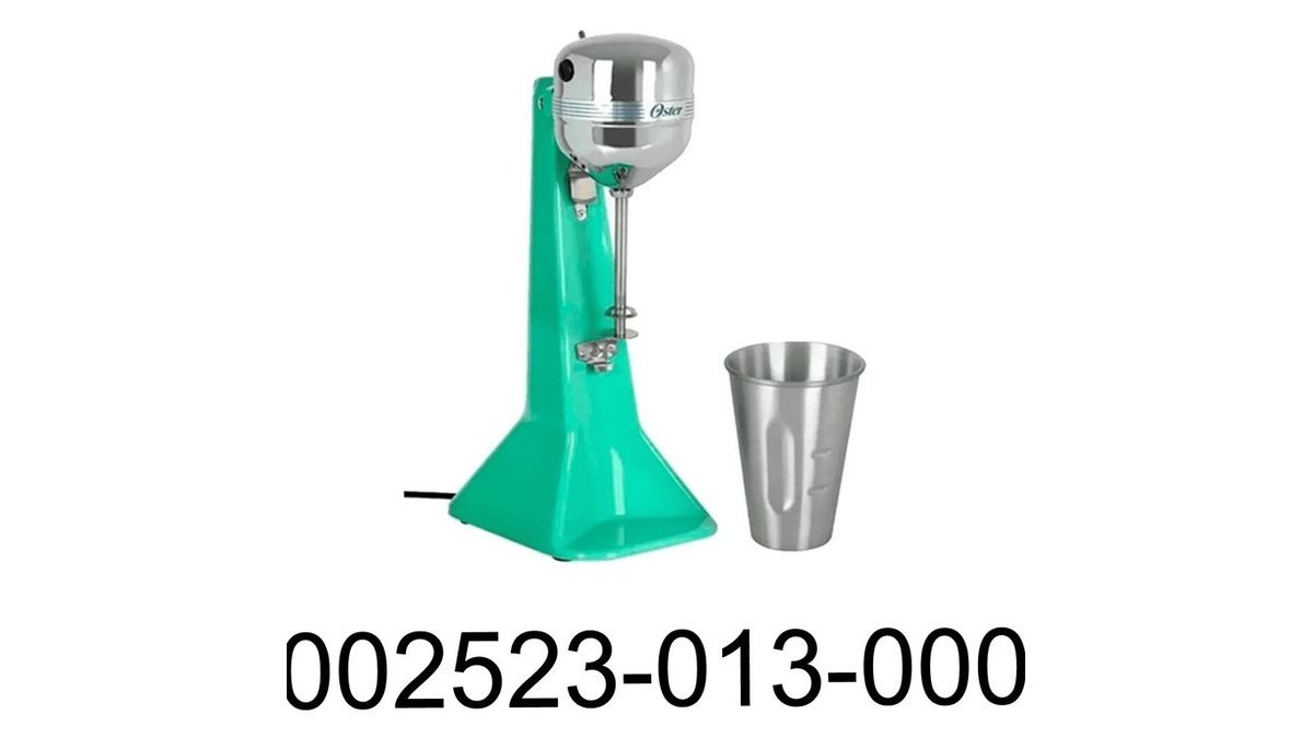 Oster hand blender on a kitchen counter beside fresh strawberries