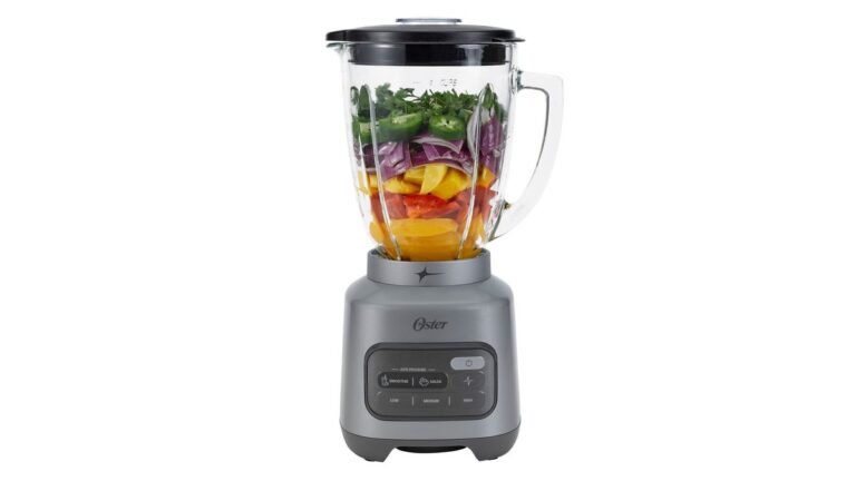Oster smoothie blender with pink smoothie on a kitchen counter