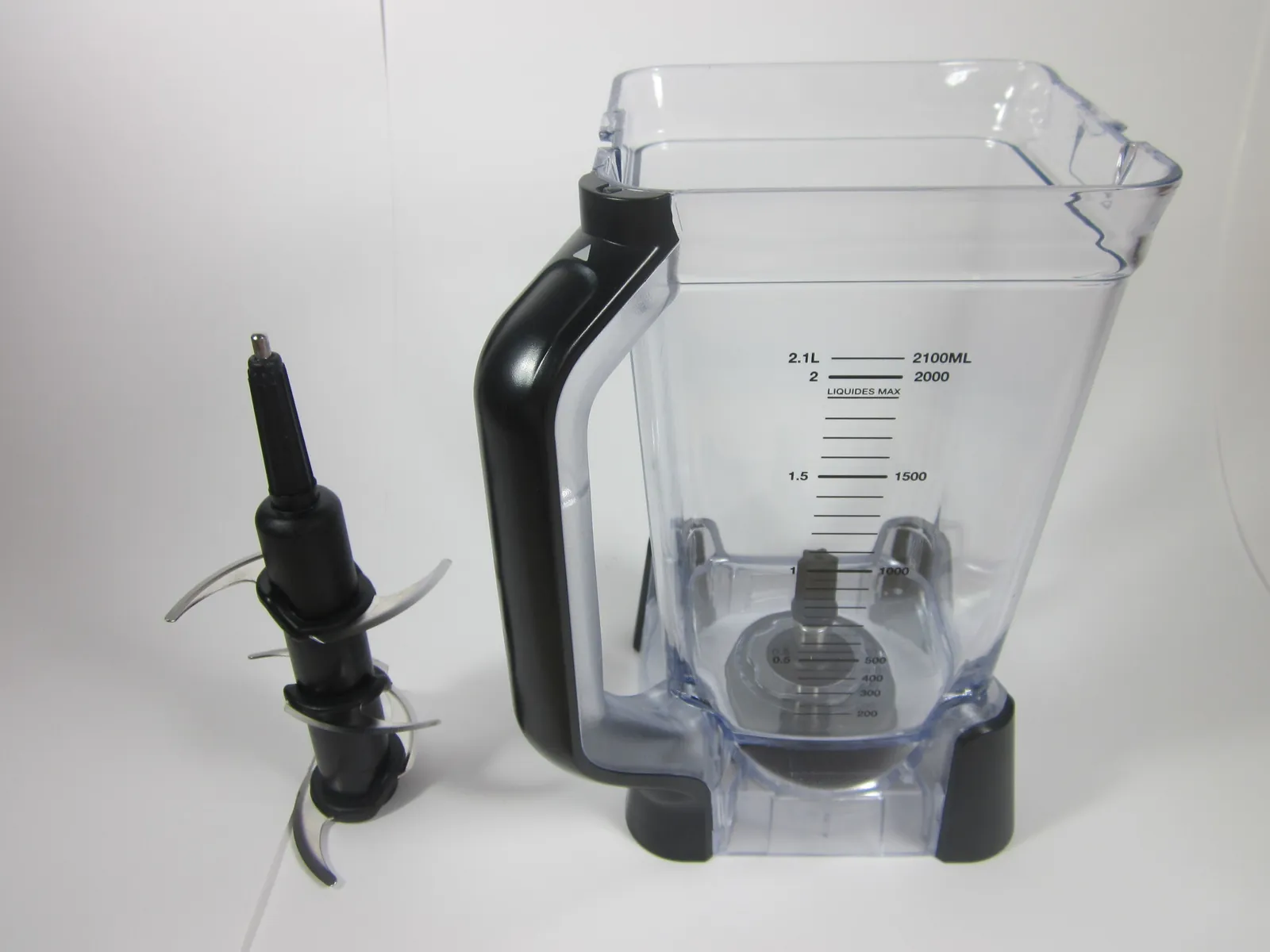 A person preparing to assemble the blade tower inside a Ninja blender pitcher.