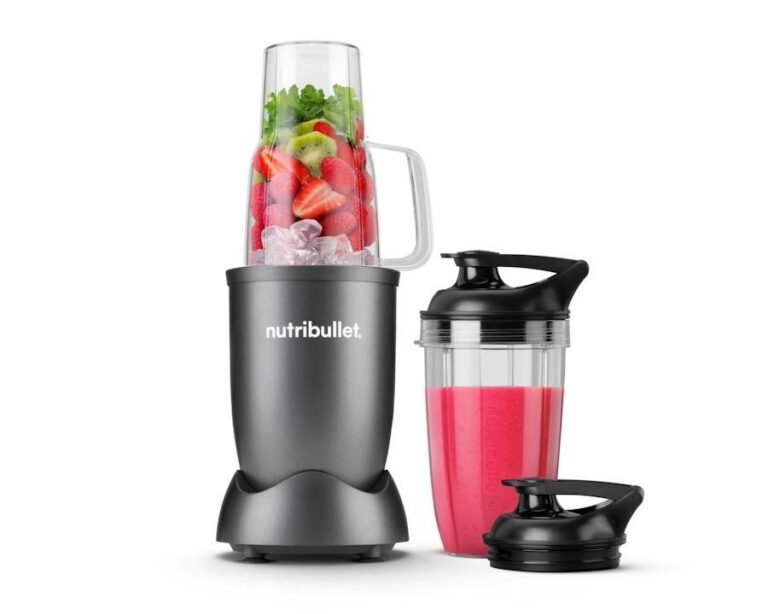 Personal blender cup beside a cooking pot on a kitchen counter