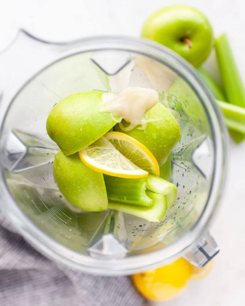 A pitcher of celery juice showing signs of oxidation on a kitchen counter.