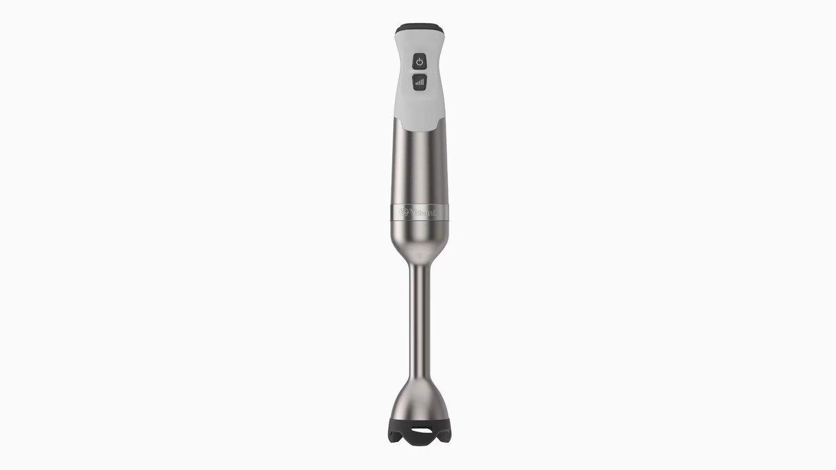 A professional Vitamix blender and an immersion blender sitting together on a modern kitchen counter.