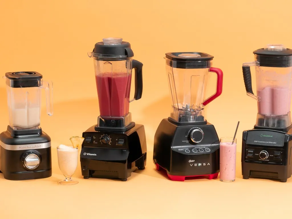 A professional Vitamix and Ninja blender sitting on a modern kitchen countertop for comparison.