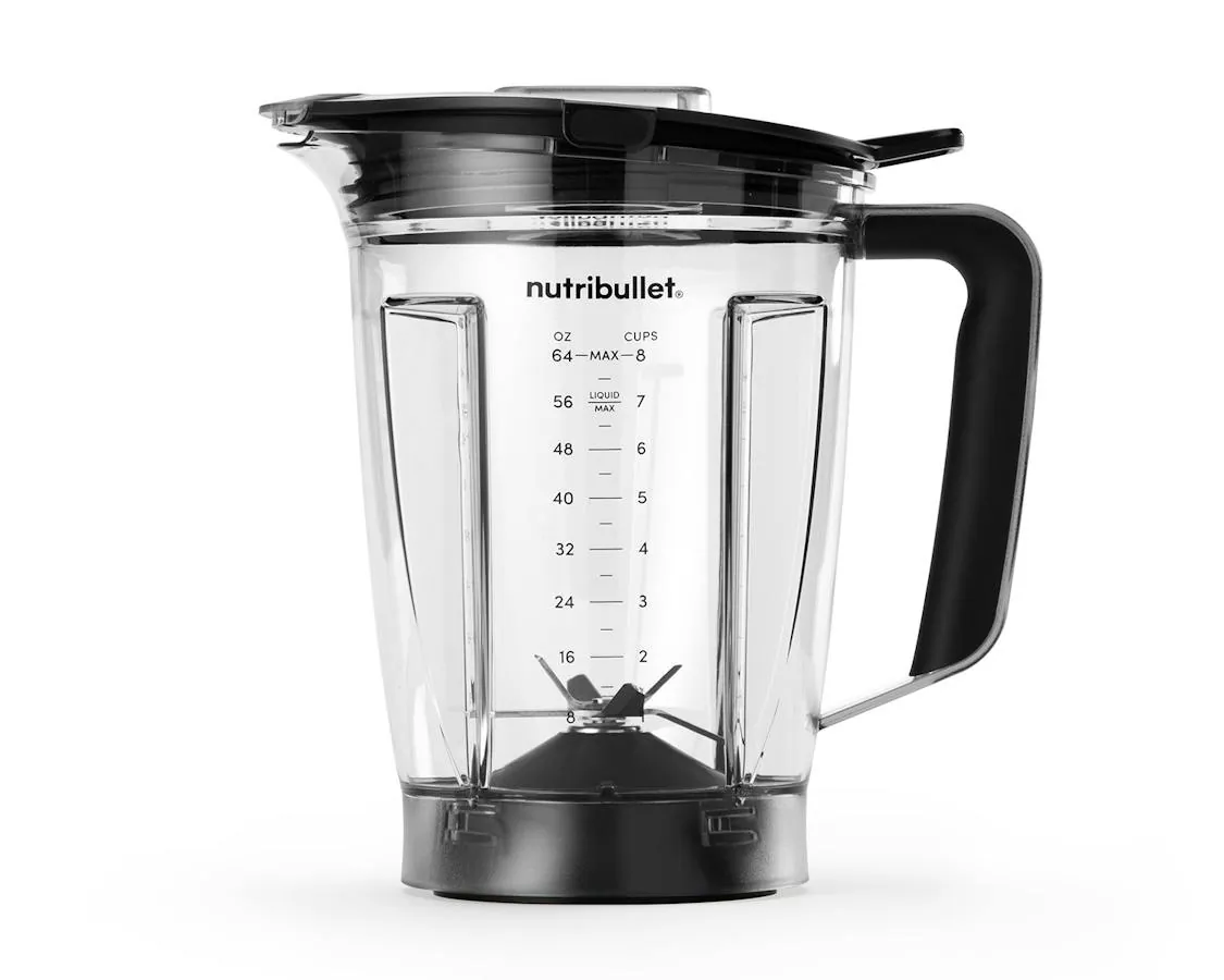 Sealed blender cup next to an open steaming pot of soup