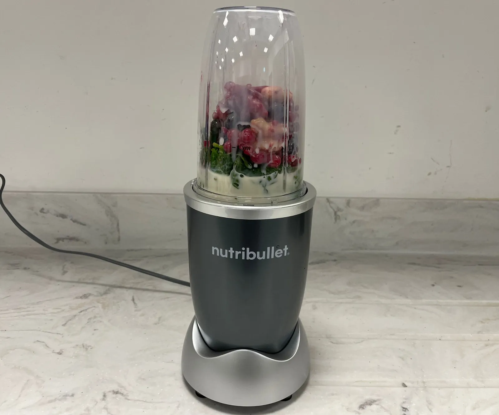 Sealed blender cups filled to the max line with a manual nearby