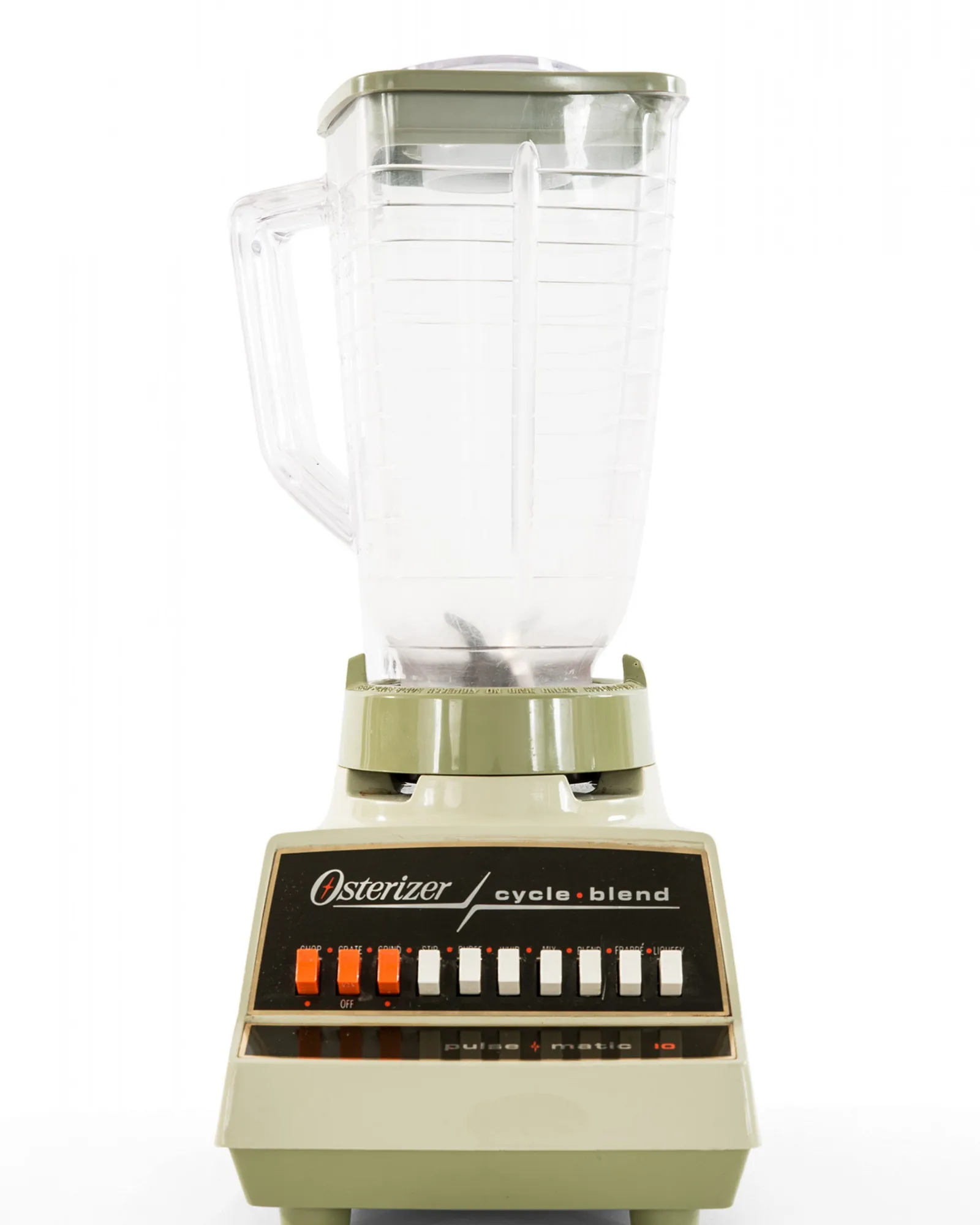 Shopper inspecting a vintage chrome Osterizer blender at a flea market table