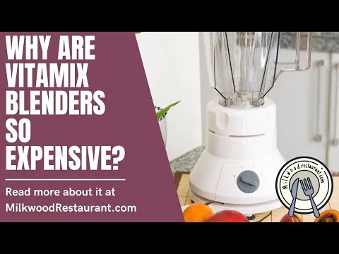 A simple, small blender sits on a kitchen counter next to a smoothie.