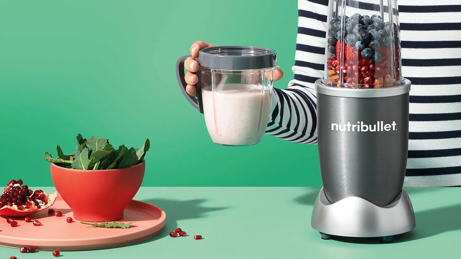 Small personal blender beside a larger full-size blender on a counter