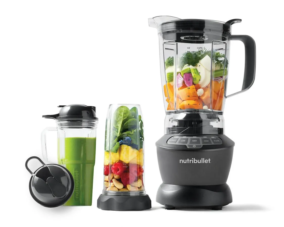 Small single-serve blender cup beside a large empty pitcher on counter