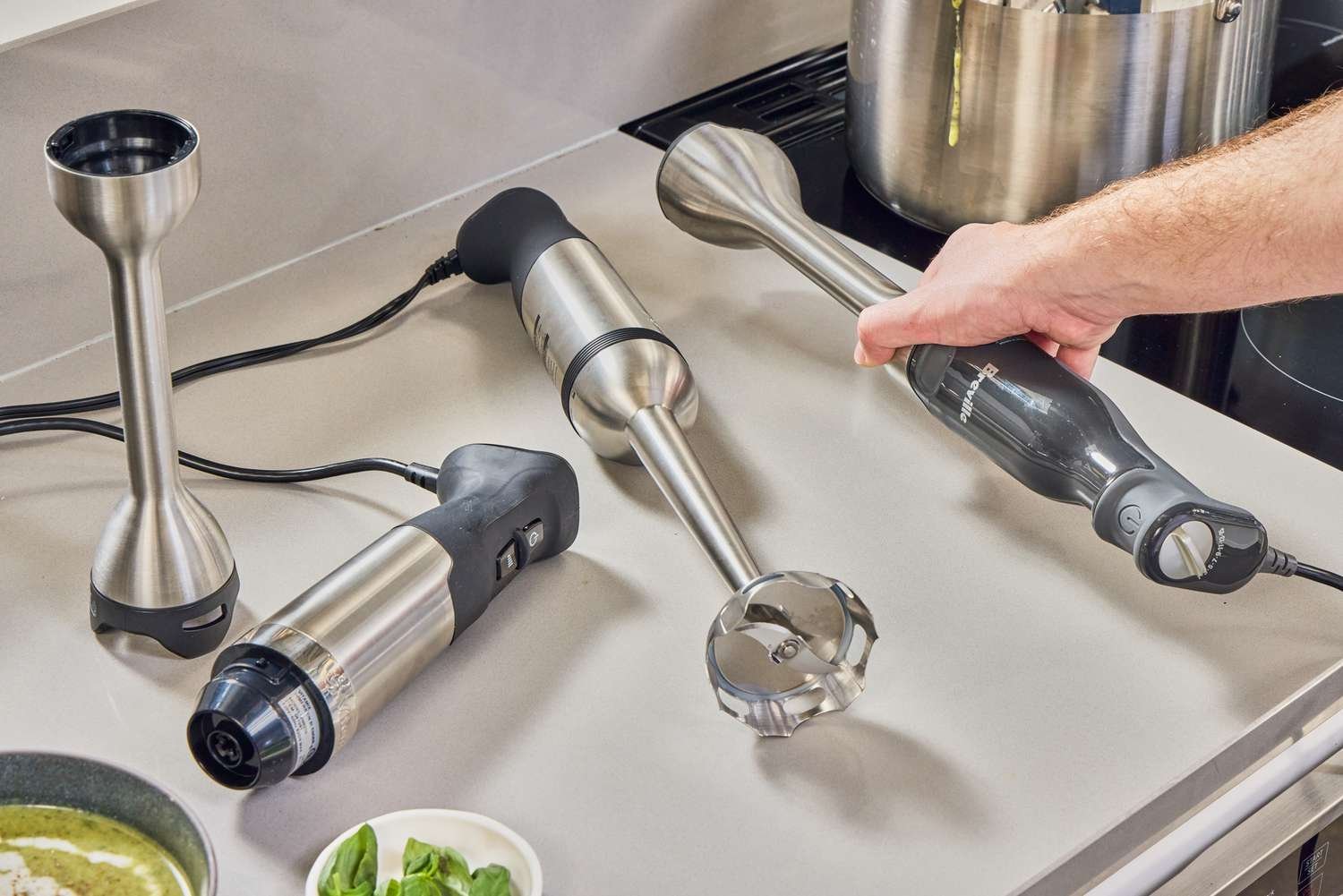 Stainless steel immersion blender on marble counter for best wattage guide.
