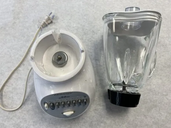 Standard Oster blender with glass jar and metal collar on counter