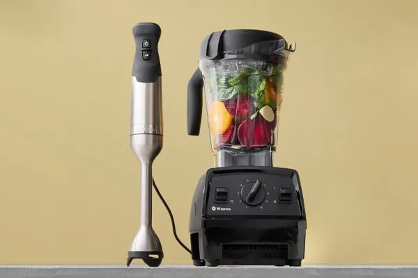 Standard Vitamix container and Dry Grains container shown together for milling wheat into flour.