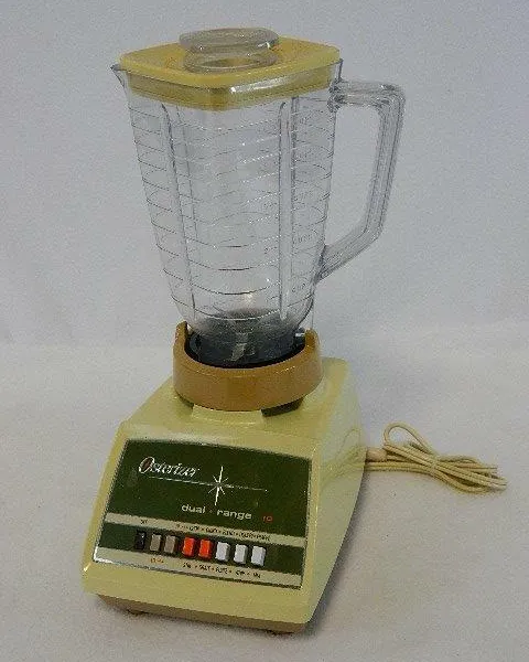 Technician's bench with an opened Oster blender base and tools