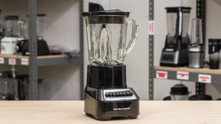 Two countertop blenders with glass and plastic jars on a kitchen counter