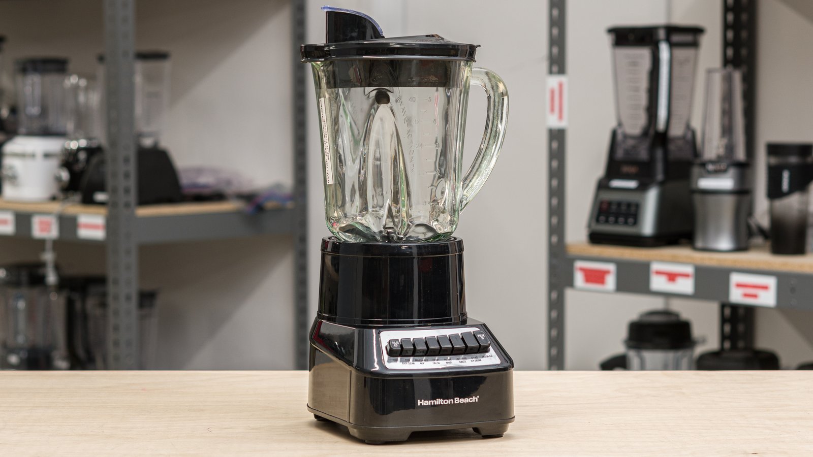 Two countertop blenders with glass and plastic jars on a kitchen counter