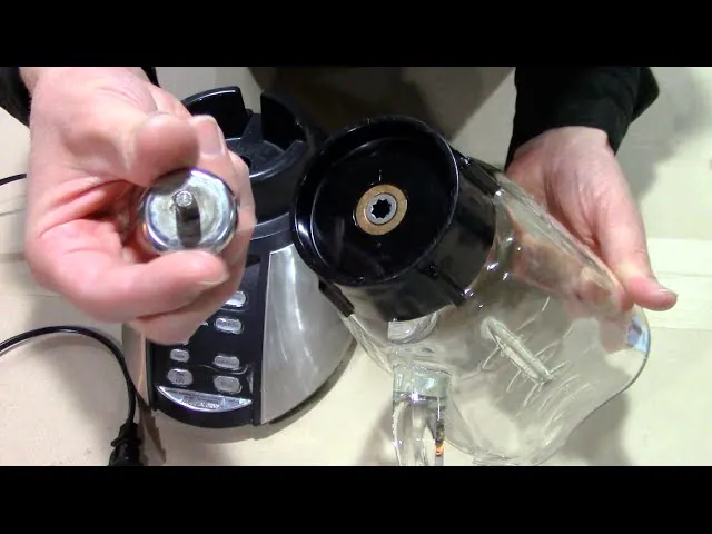 Two Oster blenders on a workbench with repair tools
