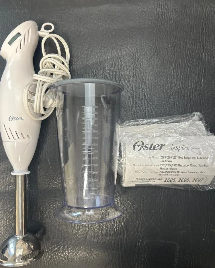 Two Oster hand blenders showing twist-lock and push-button release collars
